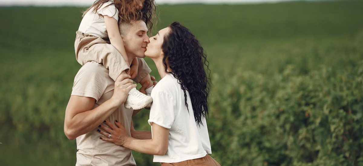 A heartwarming family moment captured in a field, highlighting love and togetherness.